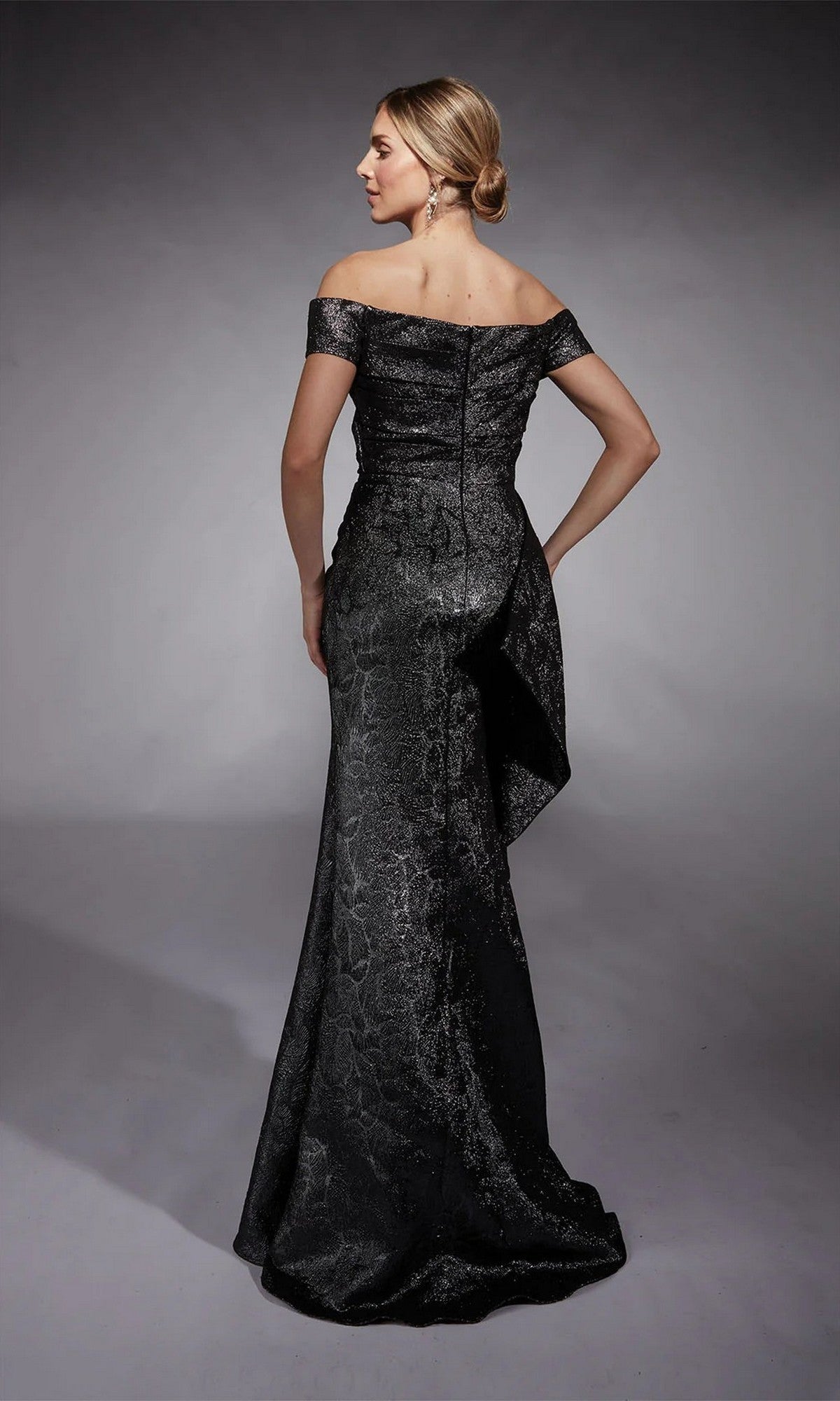 Woman in the Long Formal Dress: Alyce 27735, a floor-length off-the-shoulder gown with subtle textured patterns, shown from the back against a gray backdrop—an elegant mother of the bride option.